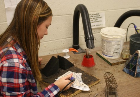 Senior Abby Combs works on her project today in stained glass.