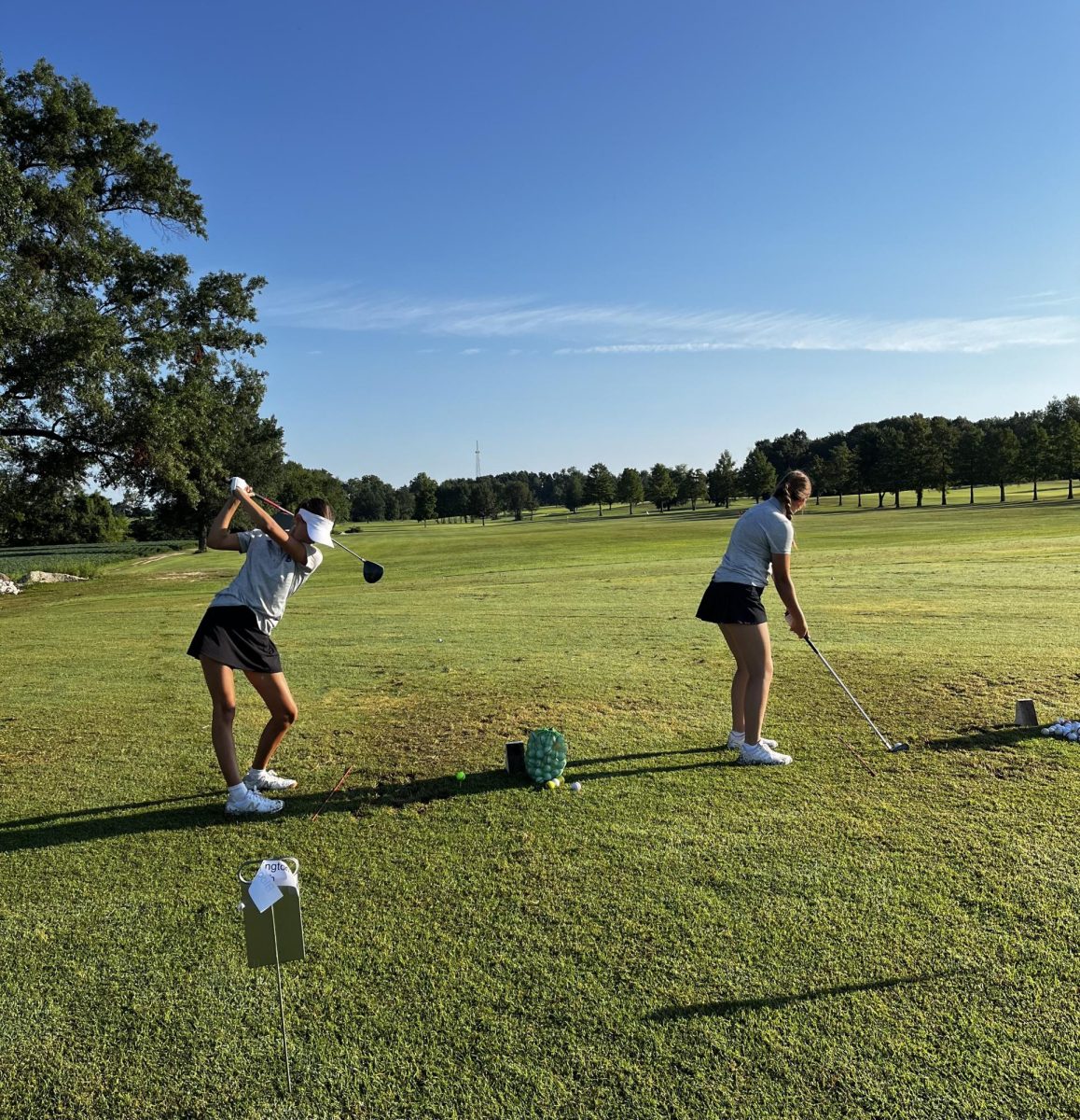 Freshmen Lyla Hough and Sophomore Silvia Walker practicing on the range before an invitational