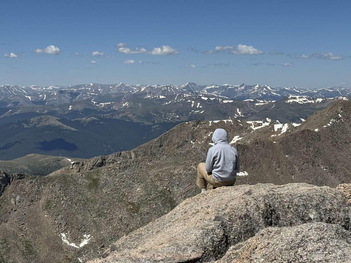 Deacon Peterman looks out on Mount. Blue Sky (courtesy of Deacon Peterman)