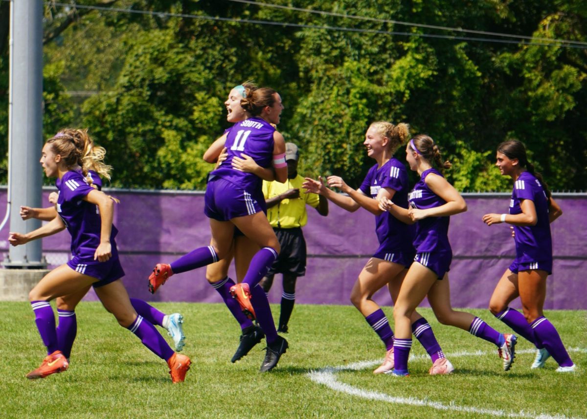 Members of the Panther girls' soccer team celebrate a goal by junior Izzy Sweet in their 3-2 season-opening victory over the Jasper Wildcats