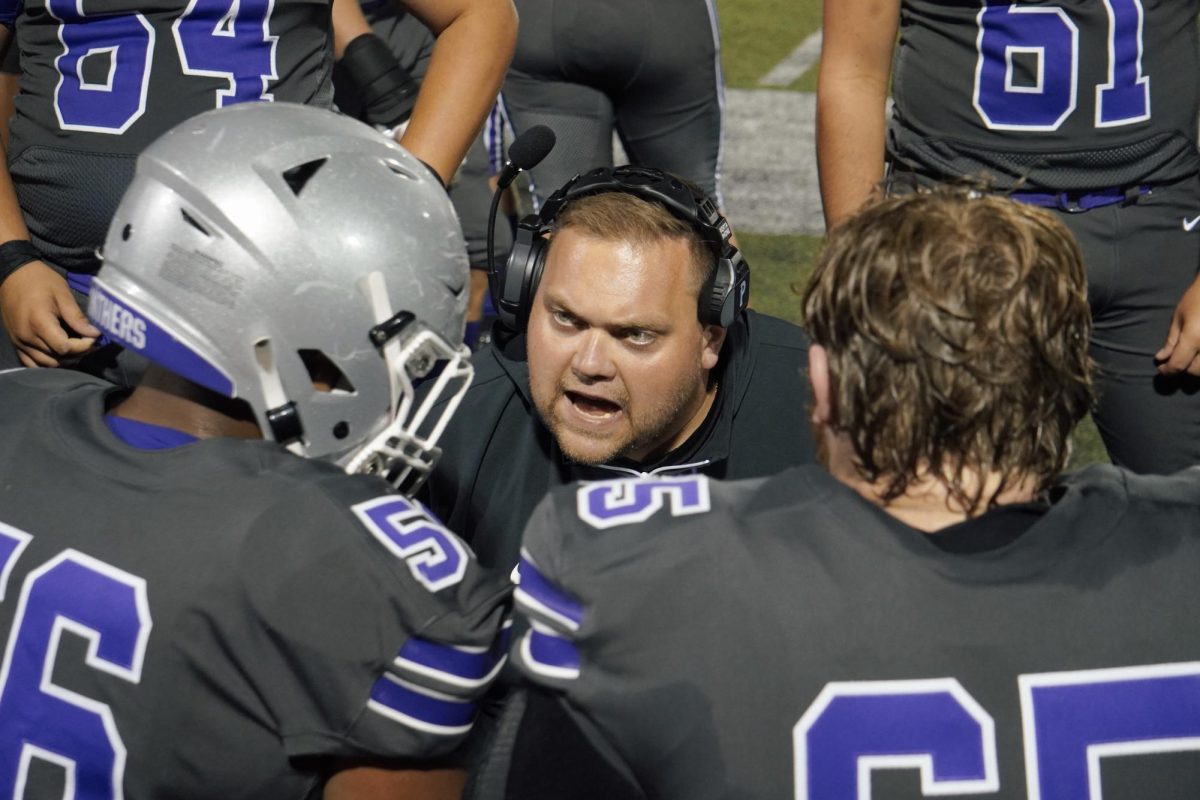 Social Studies teacher and offensive line coach AJ Abplanalp motivates his players on the sideline during South's game against Terre Haute North on Friday, September 6