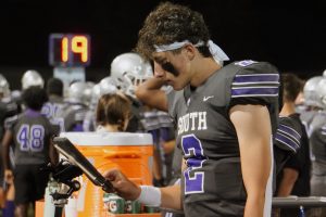 South's sophomore quarterback Duncan Combs (2) analyzes a play from the sidelines during the Panther's home opener against Terre Haute North on Friday, Sept. 6, 2024.