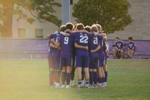 Members of the Bloomington South boys soccer team huddle up before to taking on the Southport Cardinals on Sept. 9, 2024. 