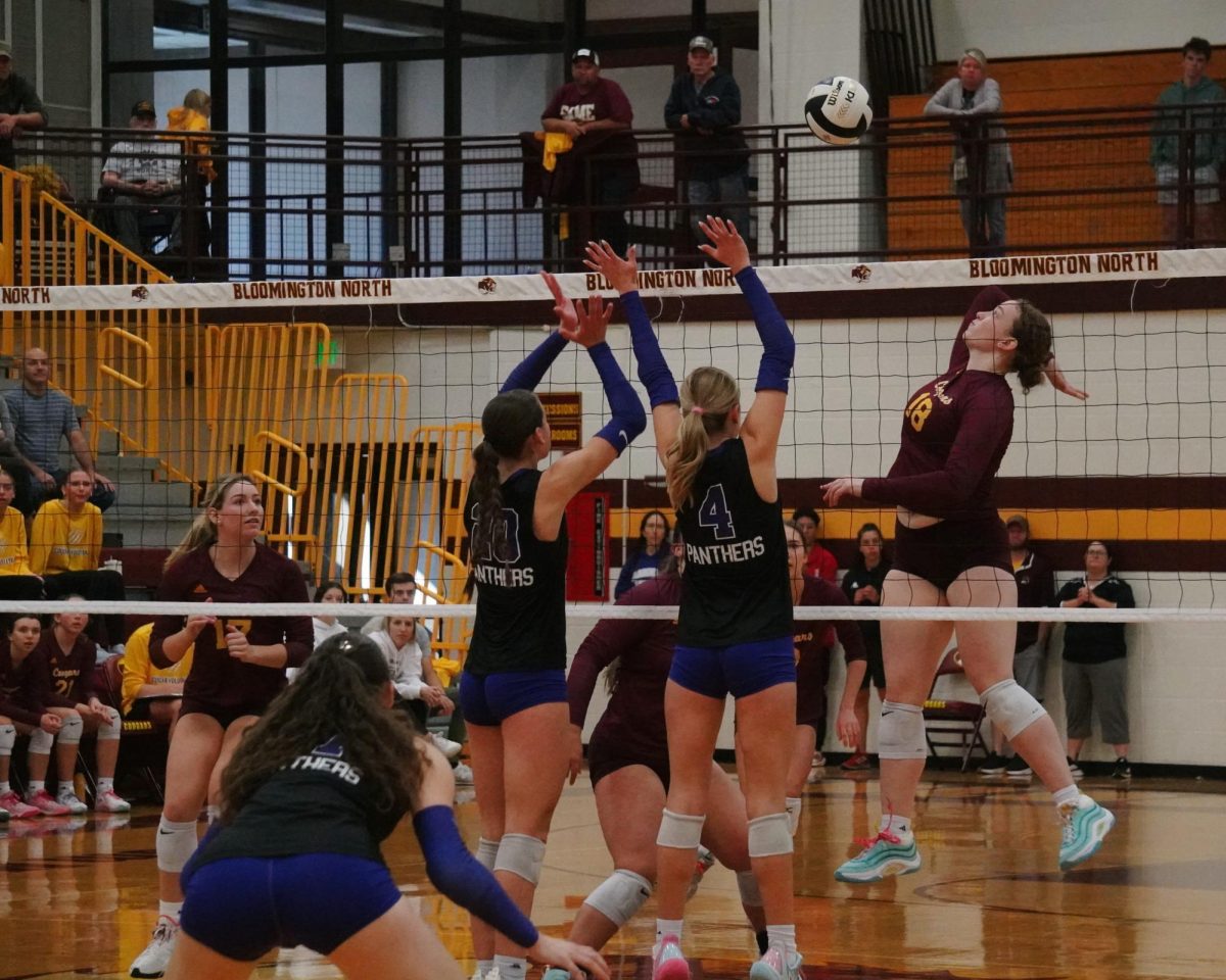 Bloomington North's Addy Myers attempts to spike the ball past South's Charlie Monroe (4) and Quinn Reynolds (20), with Olivia Roberts positioned in the backcourt, during their sectional match on Saturday, Oct. 19. The Panthers lost in straight sets.