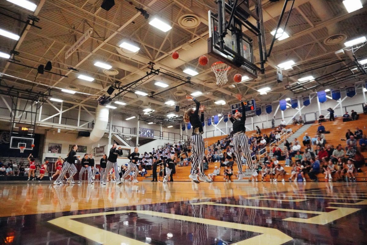 Members of the Panther girls basketball team warm up before facing the Bedford North Lawrence Stars on Nov. 19, 2024.