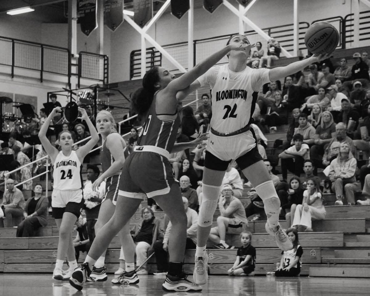 Bloomington South’s Violet Hall (22) stretches for a layup under pressure from Bedford North Lawrence’s Makaya Jackson (30) during a home game on Nov. 19, 2024. The Panthers won 50-25.  